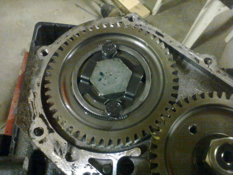 An impact gun makes short work of removing the fasteners for these gears. But first, the retaining clip must be removed from the output gear’s bolt.